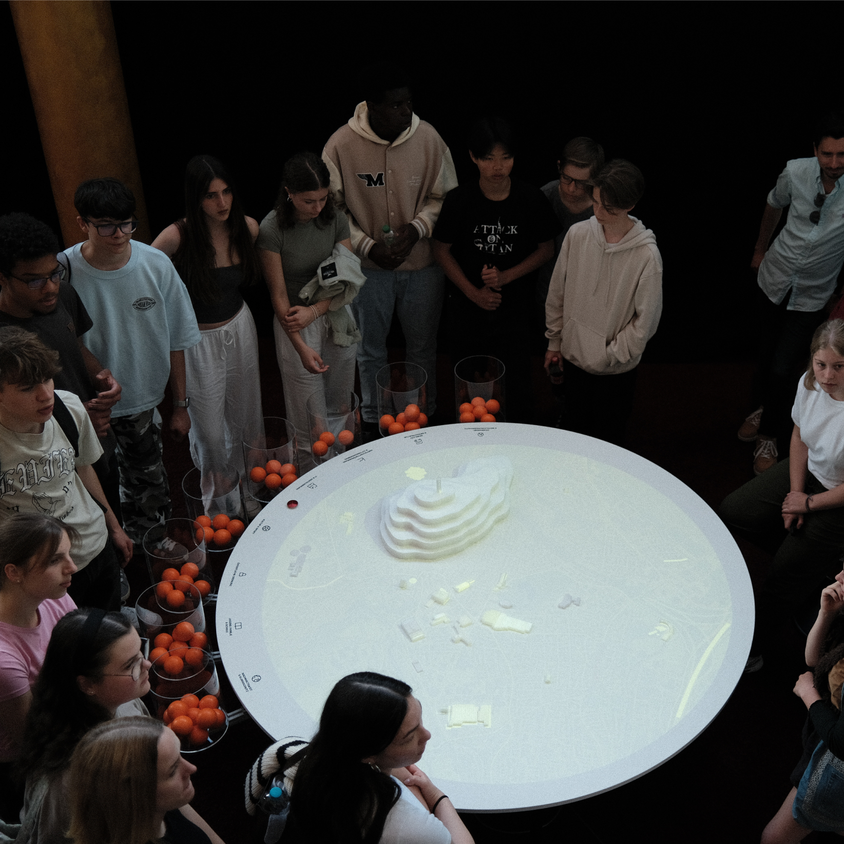 Students standing around an interactive game table